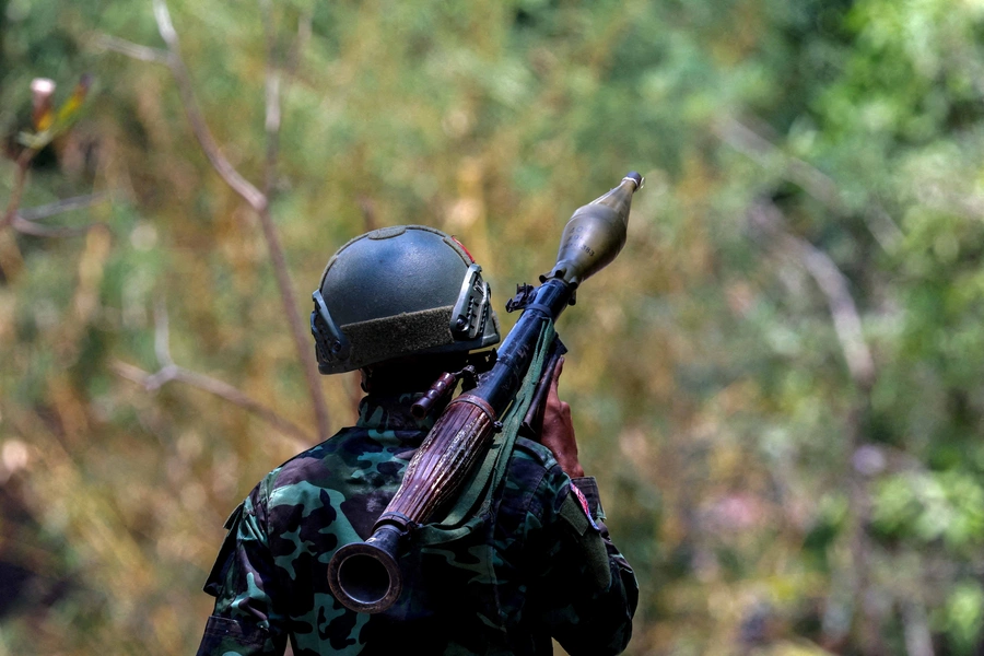 A soldier from the Karen National Liberation Army (KNLA) carries an RPG launcher at a Myanmar military base at Thingyan Nyi Naung village on the outskirts of Myawaddy, the Thailand-Myanmar border town, on April 15, 2024. 